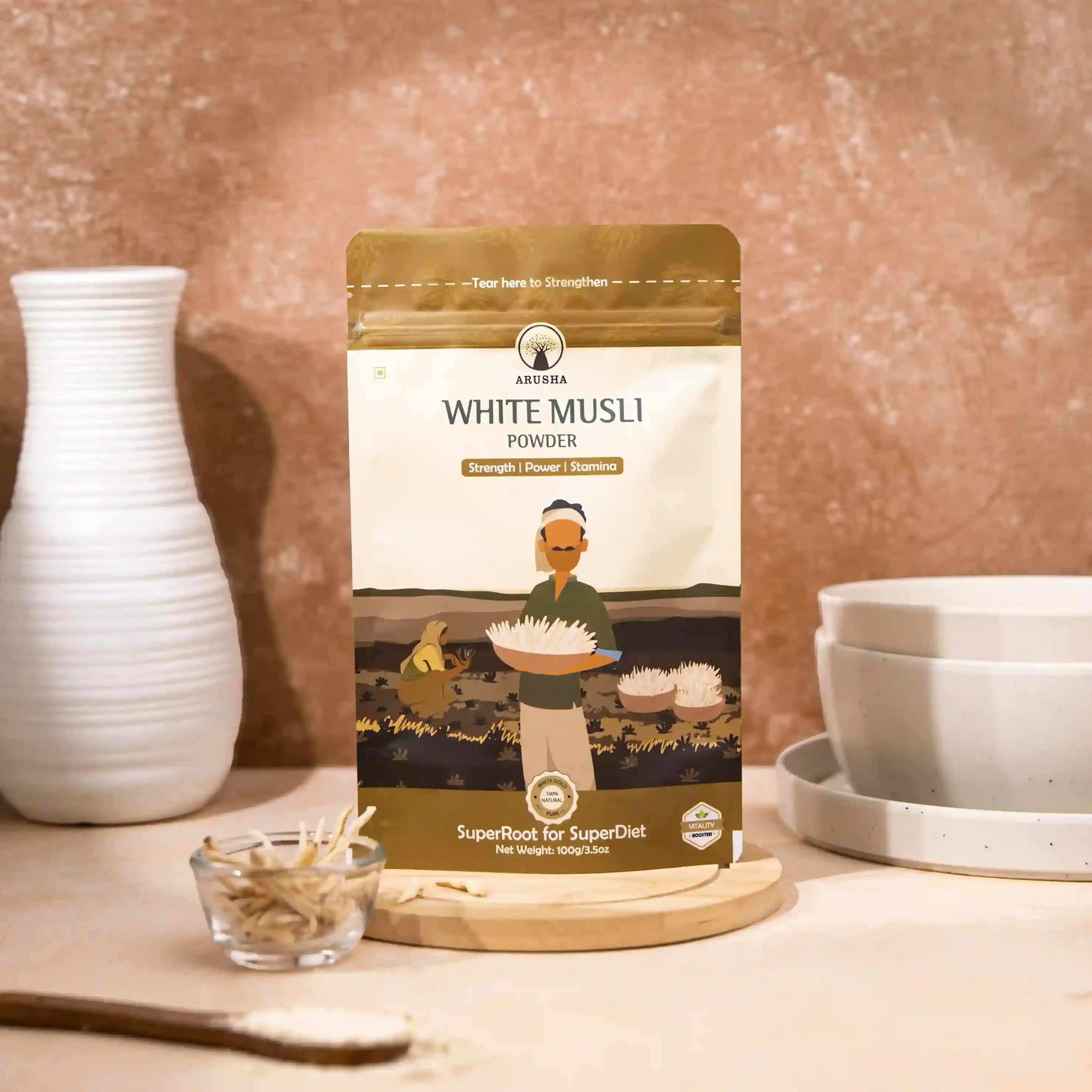 Arusha white musli powder pack displayed with dried musli roots on a wooden surface